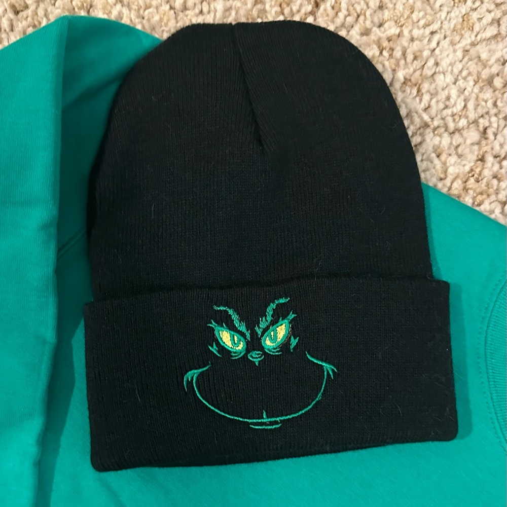 Black beanie with the Grinch embroidered on the front.
